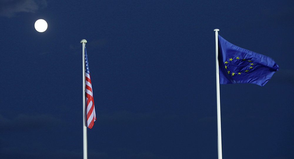 EU and US flags seen beneath the moon EU and US flags seen beneath the moon