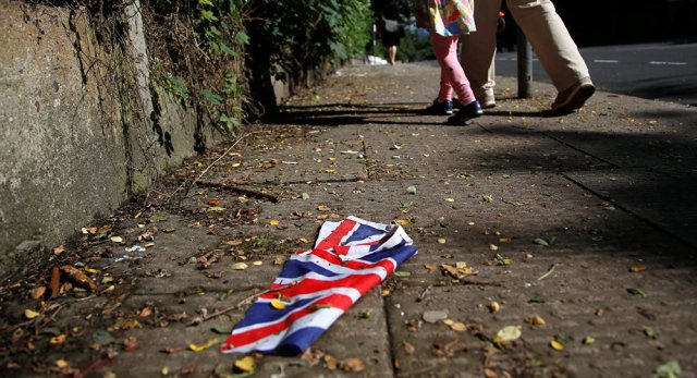 A British flag which was washed away by heavy rains the day before lies on the street in London, Britain, June 24, 2016 after Britain voted to leave the European Union in the EU BREXIT referendum.
